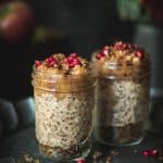 Side view of apple pie overnight oats with a dark, moody background