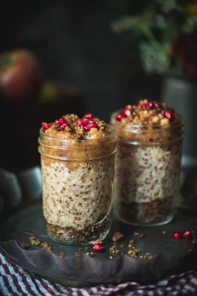 Side view of apple pie overnight oats with a dark, moody background