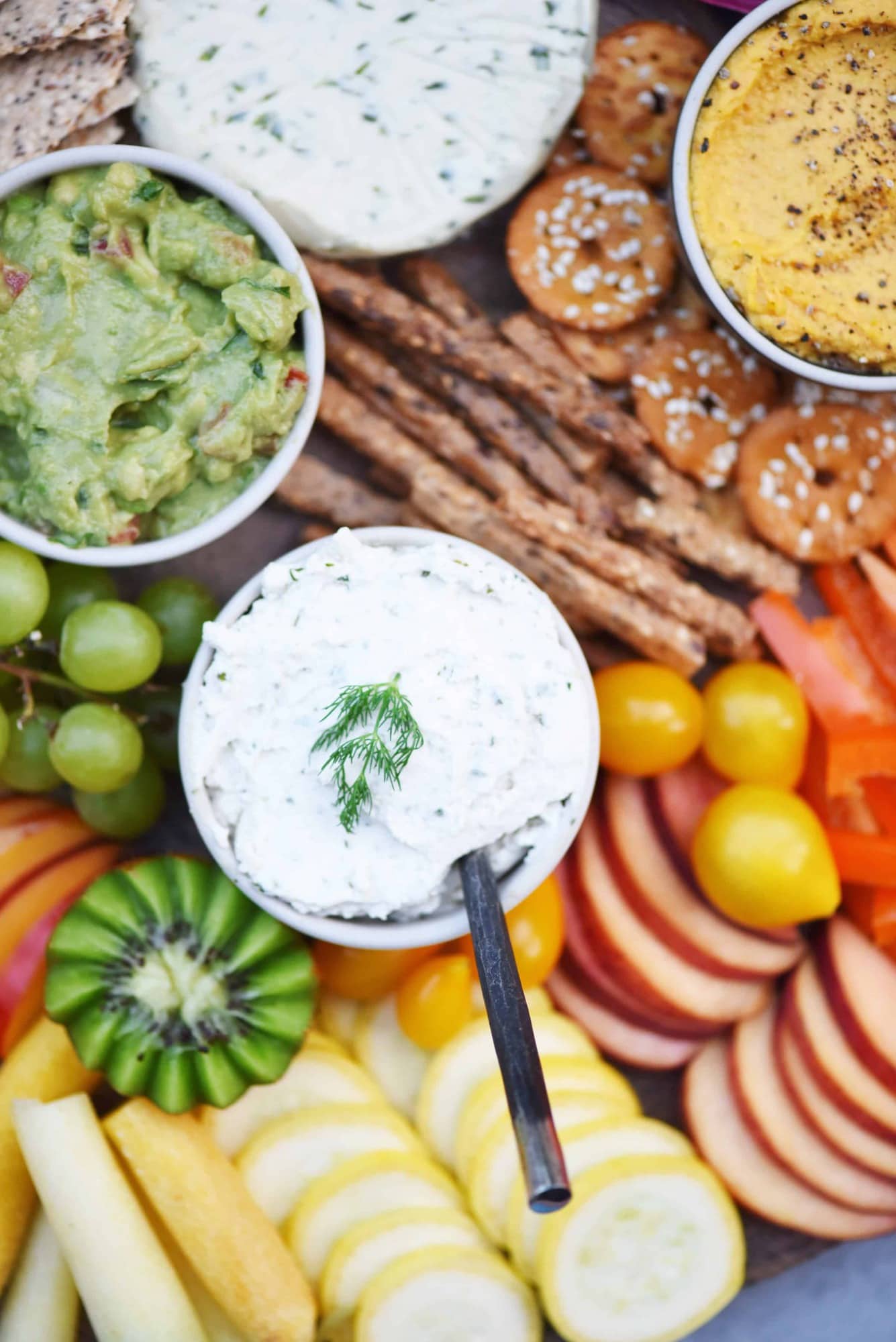 Close up of vegan chive dip on a rainbow snack platter