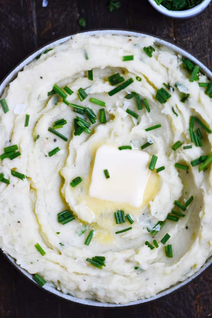 Close up of vegan mashed potatoes with melting butter and chives