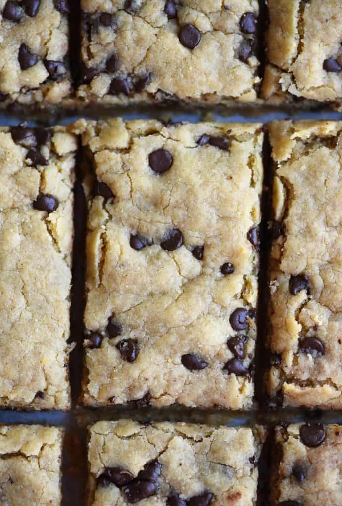 Overhead of chocolate chip cookie bar with bite taken out on a dark background