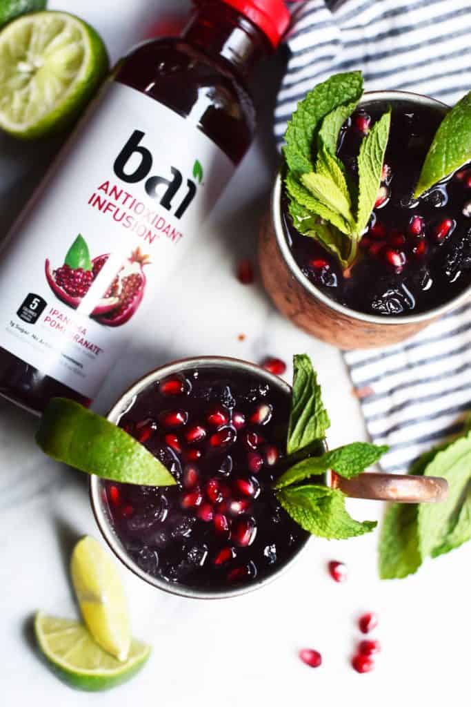 Overhead of pomegranate moscow mule garnished with mint and lime