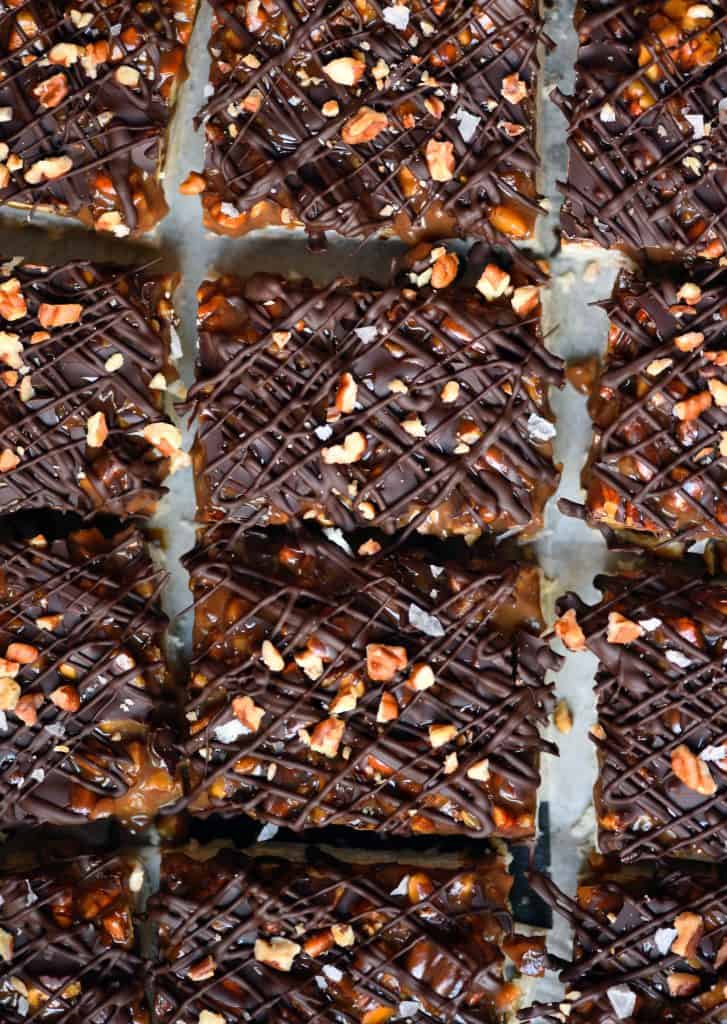 Overhead of pecan caramel shortbread bars with drizzled dark chocolate