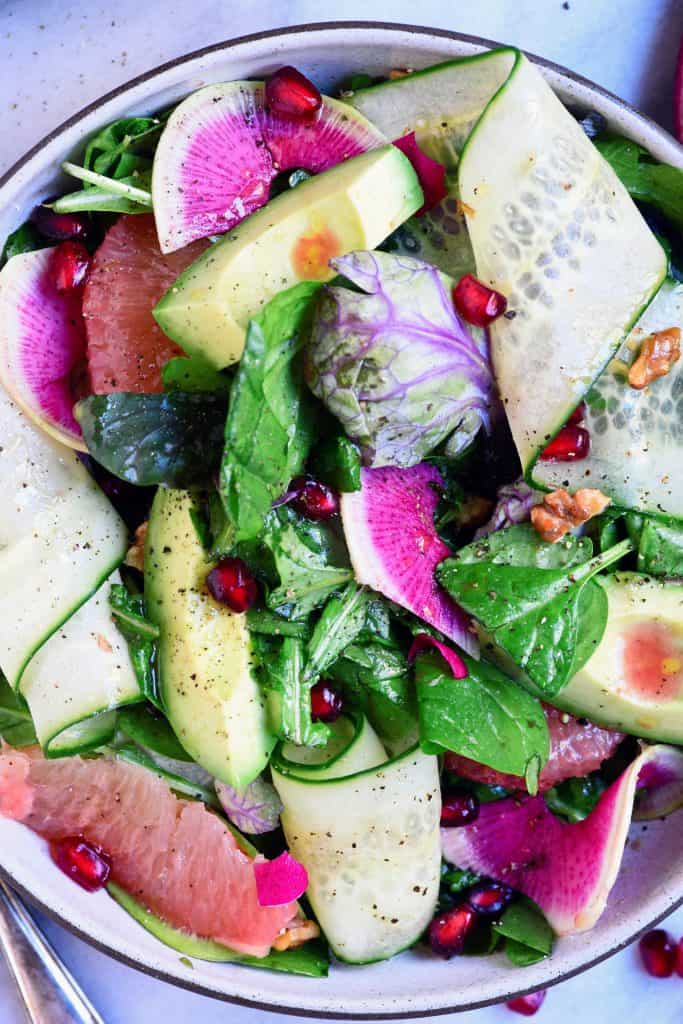 Close up overhead of citrus avocado salad with watermelon radish