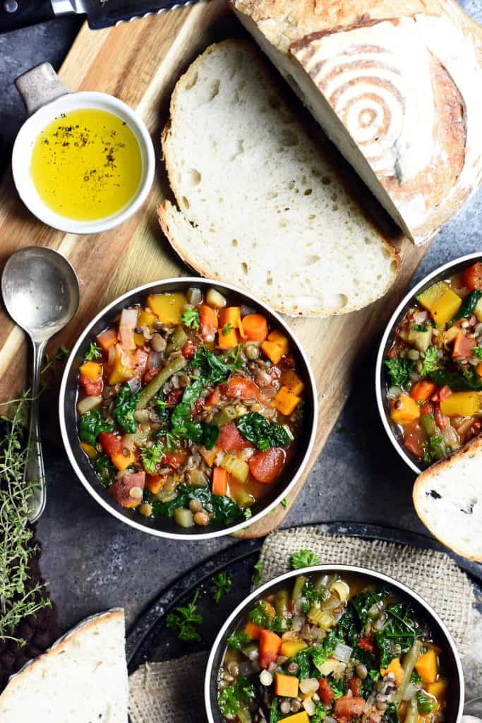 Overhead of lentil vegetable soup in black bowl