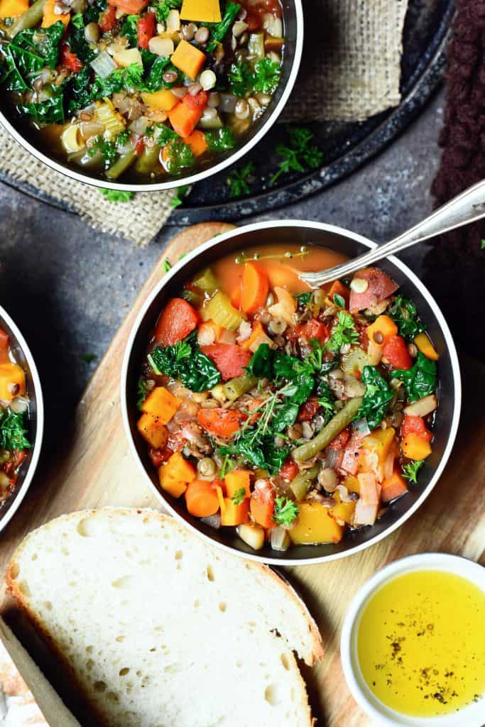 Overhead of lentil vegetable soup in black bowl