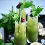 Side view of green matcha cocktail garnished with fresh mint