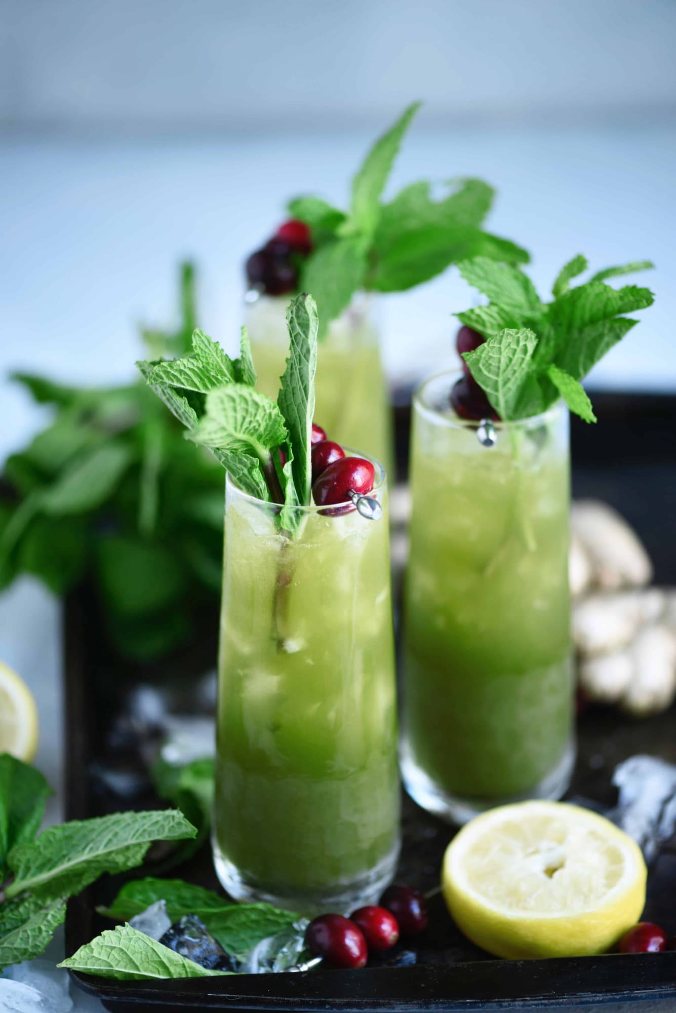 Side view of green matcha cocktail garnished with fresh mint