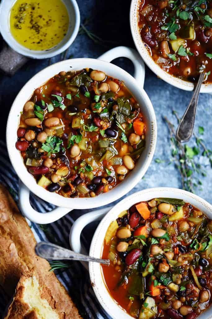 Overhead of five bean vegetable soup in a white bowl