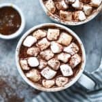 Overhead of salted caramel maca hot cocoa with vegan marshmallows with shaved dark chocolate
