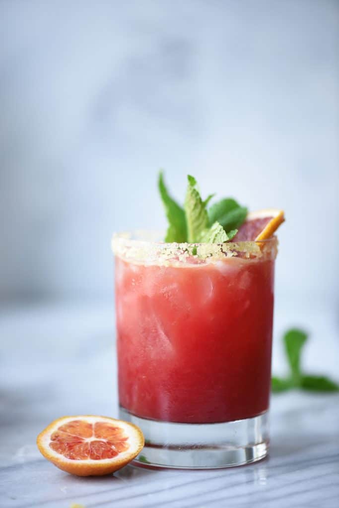 Side view of blood orange kombucha margarita with mint