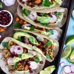 Overhead view of shiitake mushroom and sweet potato tacos on blue background