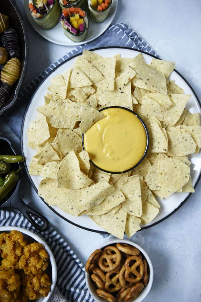 Circular platter with tortilla chips and vegan queso dip