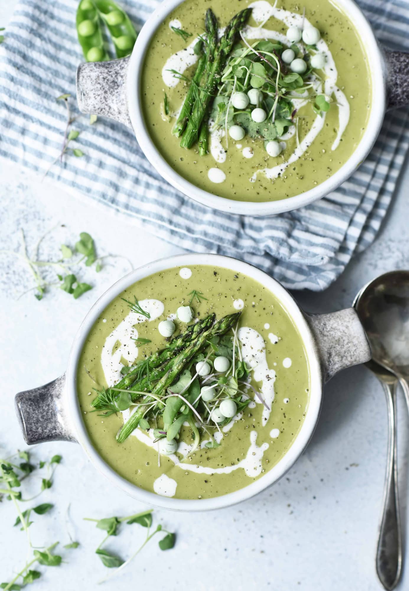 Overhead of asparagus soup with asparagus and peas