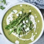 Overhead of asparagus soup with asparagus and peas