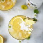 Overhead of mango coconut pineapple rum punch on a white background