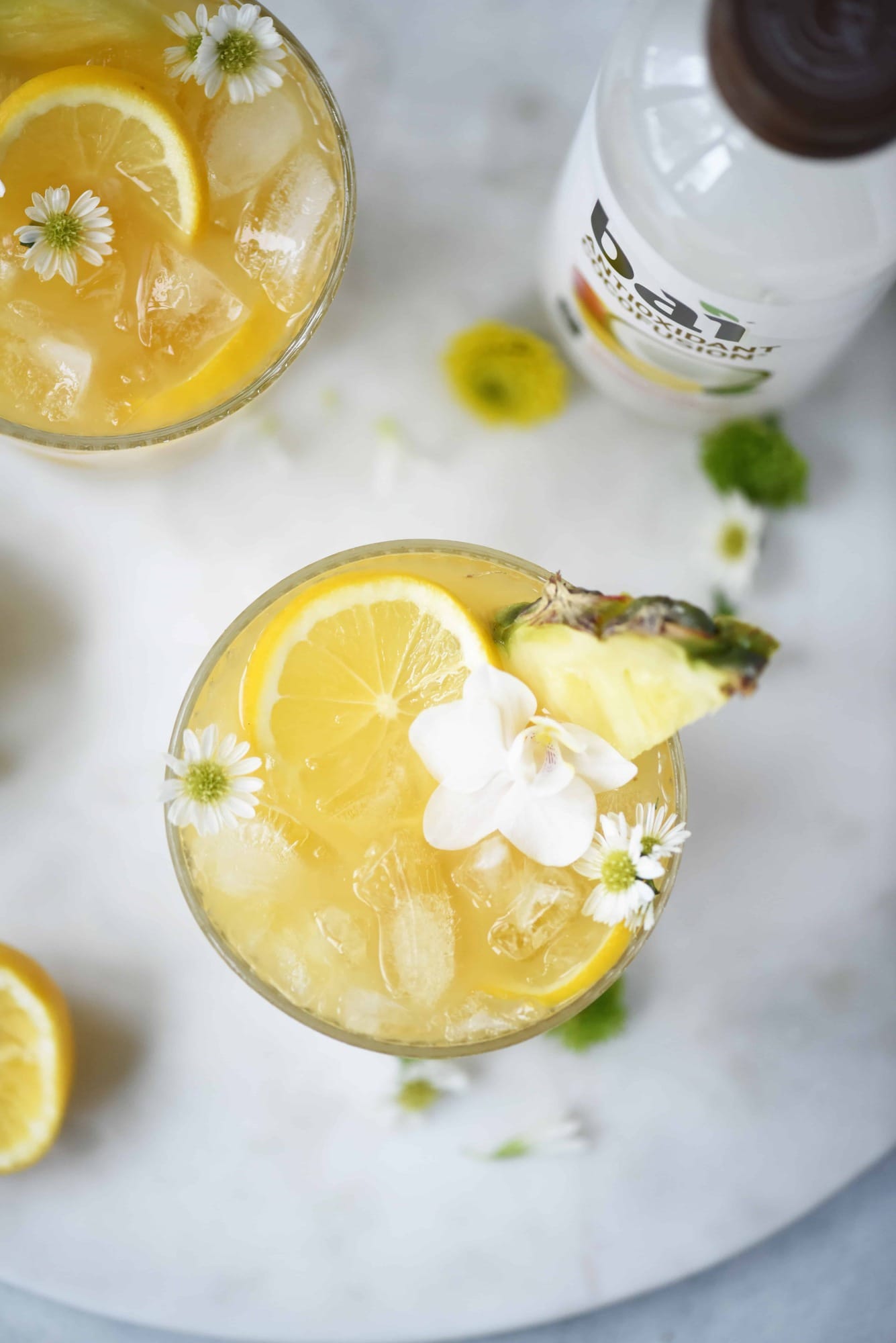 Overhead of mango coconut pineapple rum punch on a white background