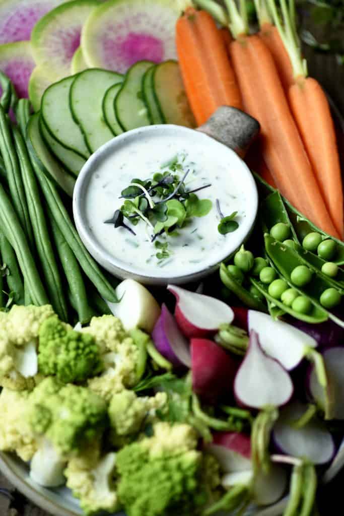 Overhead of vegan ranch on a platter with fresh vegetables