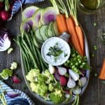 Overhead of vegan ranch on a platter with fresh vegetables