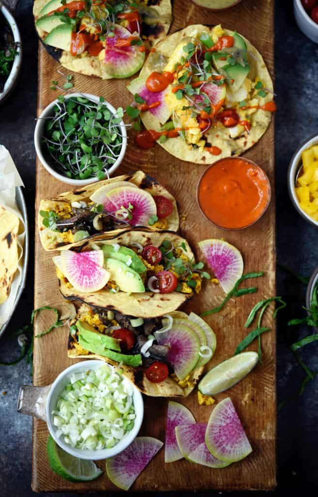 Close up of scrambled tofu breakfast tacos with watermelon radish and avocado