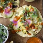 Close up of scrambled tofu breakfast tacos with watermelon radish and avocado