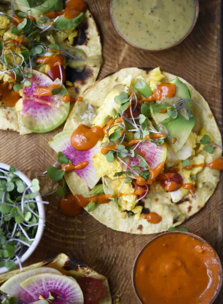 Close up of scrambled tofu breakfast tacos with watermelon radish and avocado