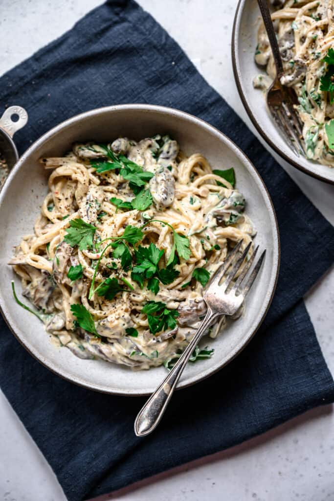 Overhead of vegan mushroom alfredo in a white ceramic bowl