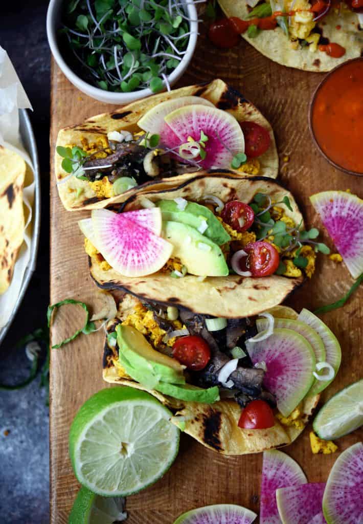 Close up of scrambled tofu breakfast tacos with watermelon radish and avocado