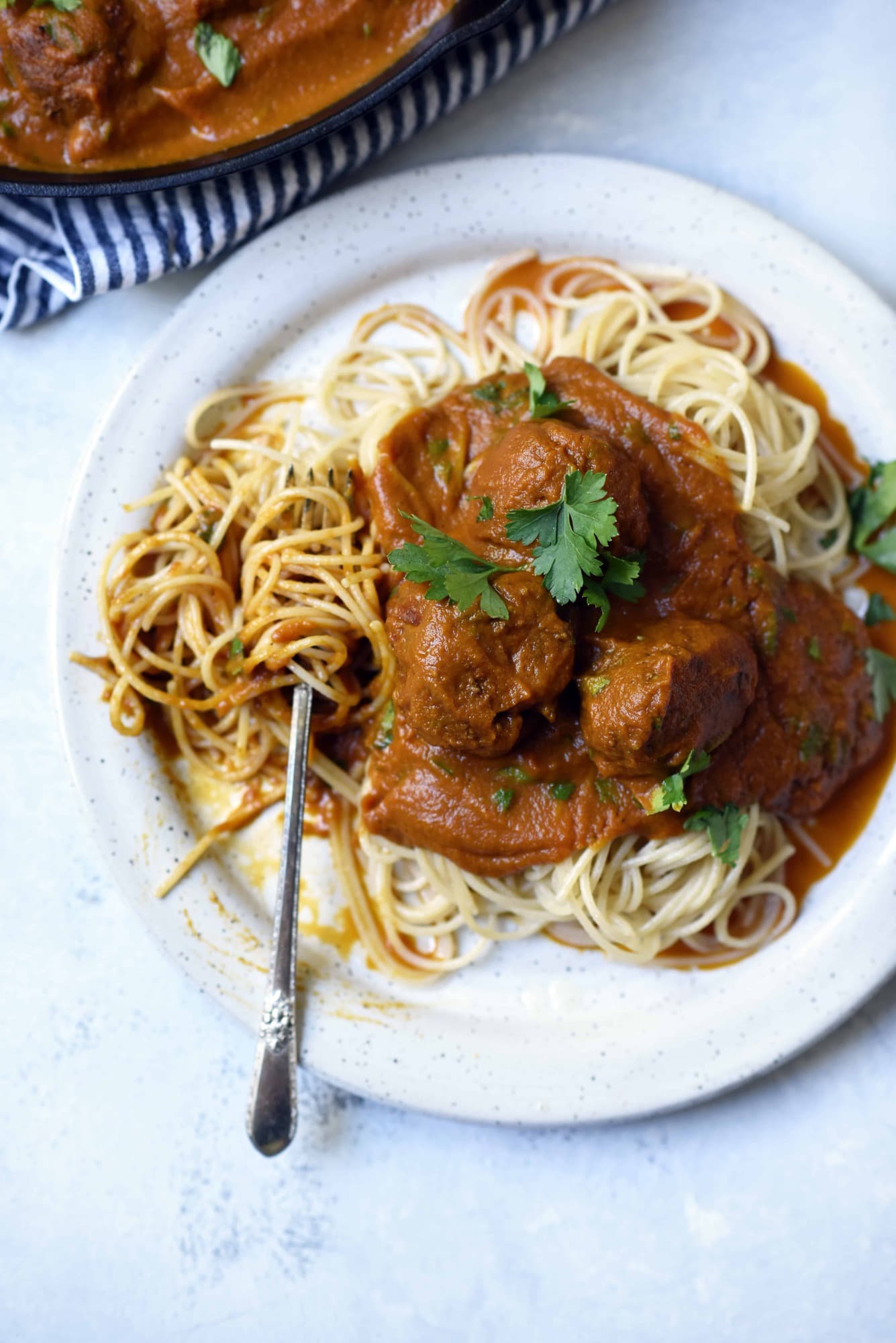 Overhead of vegan juice pulp meatballs and spaghetti on a white plate