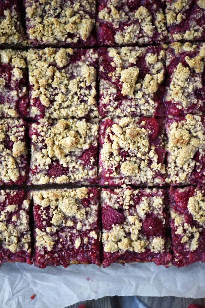 Overhead of sliced raspberry oatmeal crumble bars with streusel topping