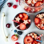 Overhead of red, white and blue sangria on a white serving platter