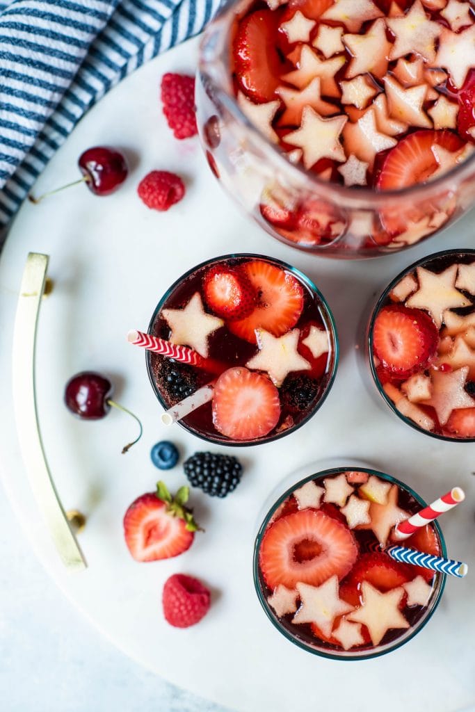 Overhead of red, white and blue sangria on a white serving platter