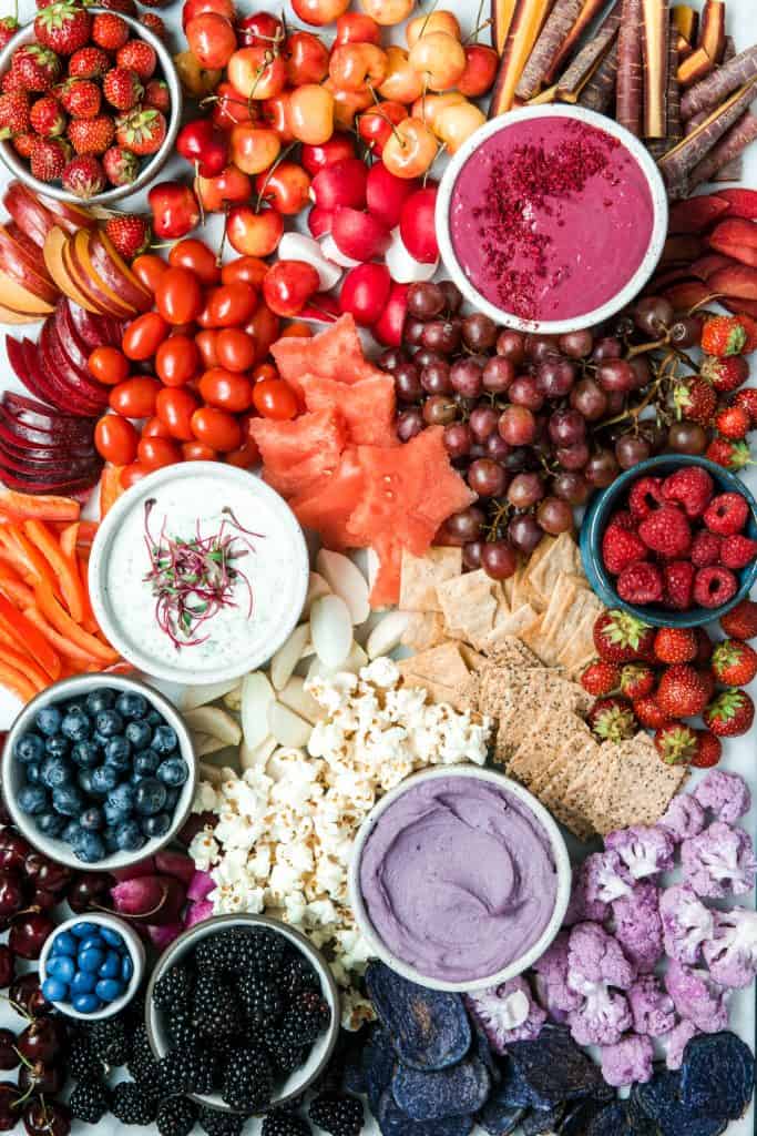 Red, white and blue snack board with colorful fruits and vegetables