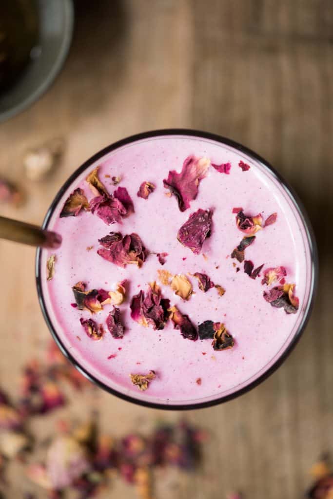 Overhead of homemade strawberry nut milk in a rose latte