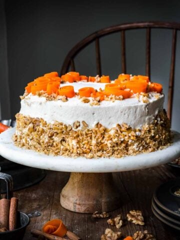 Front view of carrot cake on a cake stand.