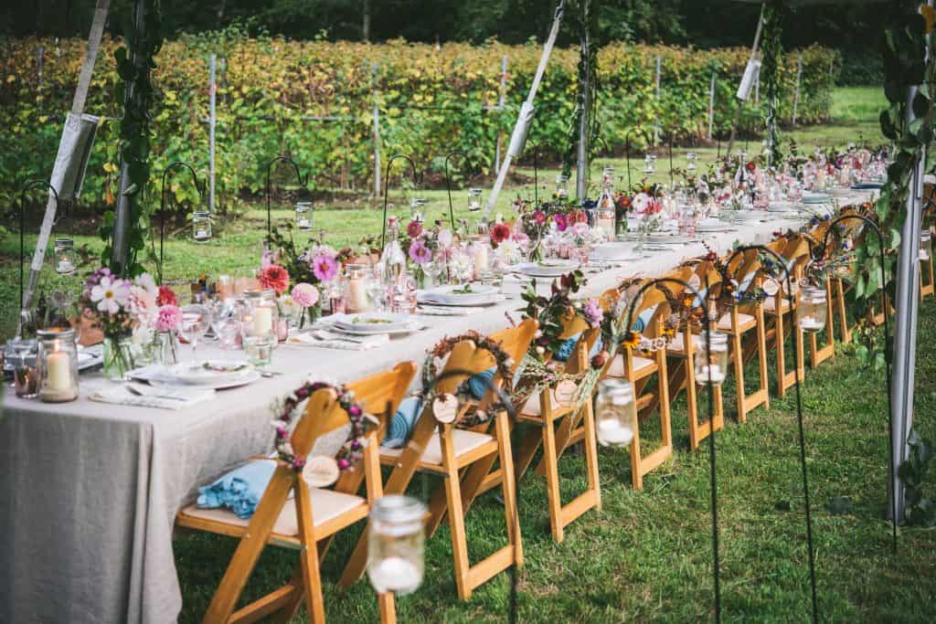 Landscape view of a long farm table set for dinner
