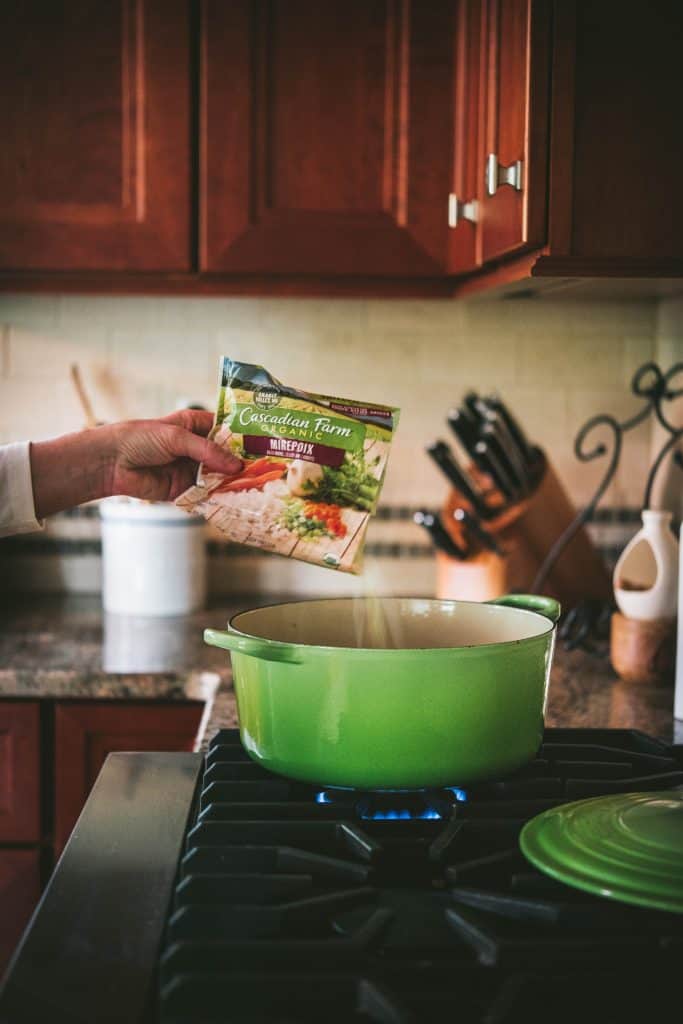 Side view of Fall Vegetable Minestrone Soup on the Stove in a green stockpot.