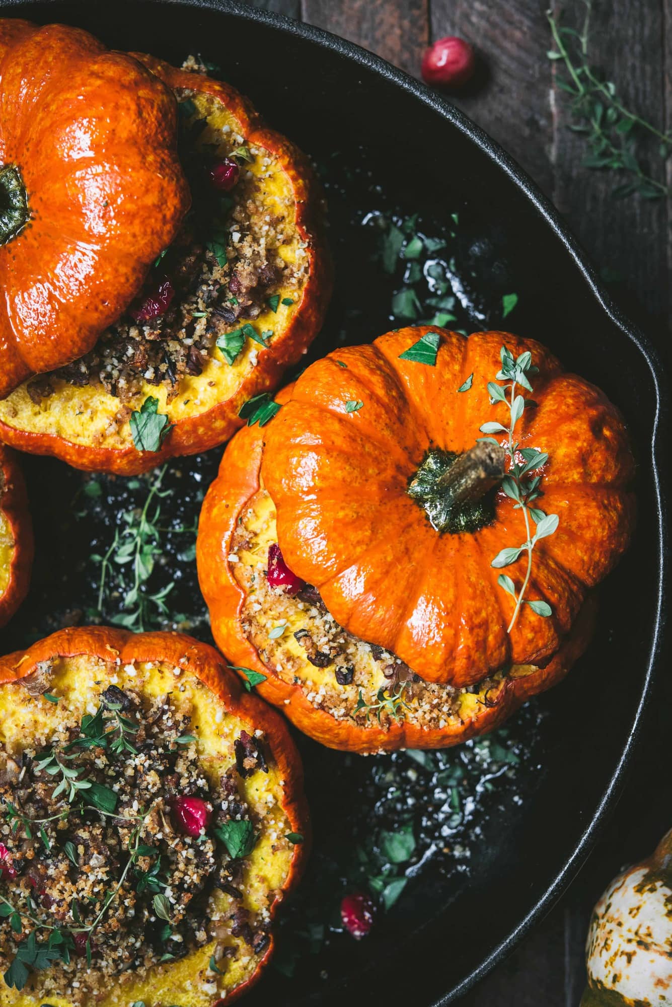 Close up view of Stuffed Mini Pumpkins with Wild Rice and Mushrooms in a cast iron skillet