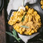 Close up overhead of vegan pumpkin mac and cheese in a mini Staub black cast iron coquette