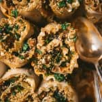 Close up of vegan butternut squash lasagna roll ups with two spoons