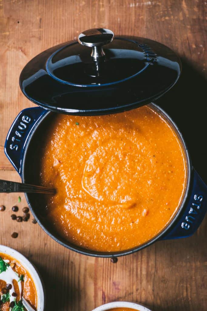 Crushed red lentil soup in a navy pot