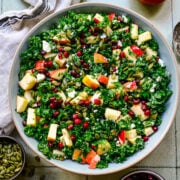 Finished kale salad in a light blue bowl.