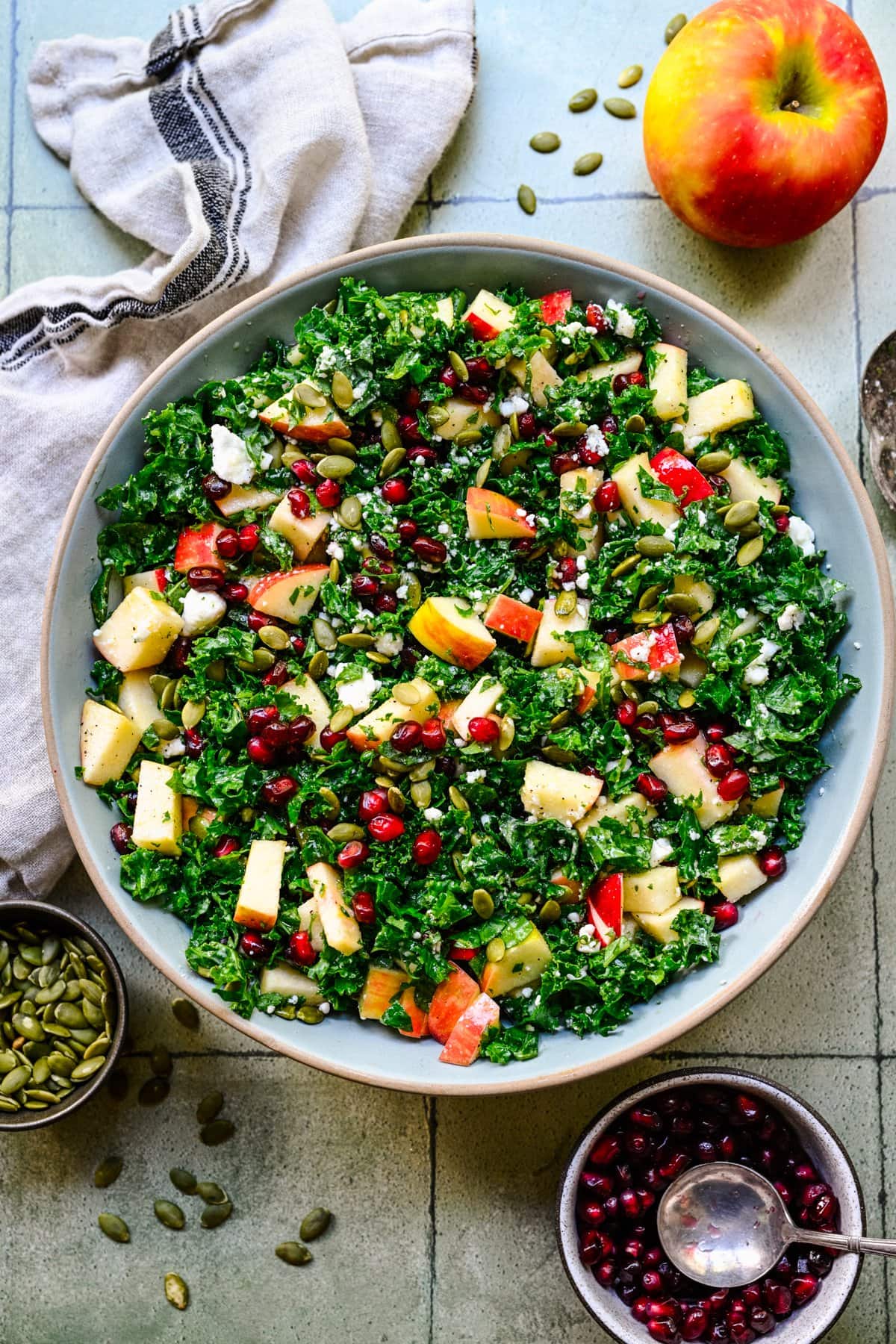 Finished kale salad in a light blue bowl.