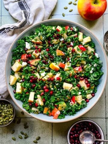 Finished kale salad in a light blue bowl.