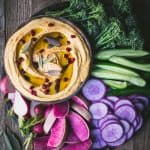 Colorful vegetable platter with bowl of creamy pumpkin hummus