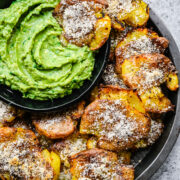 Finished potatoes in a tin with dipping sauce.