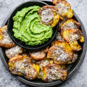 Finished air-fryer smashed potatoes with a dipping sauce.