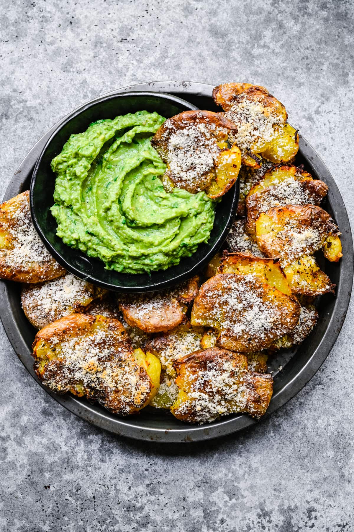 Finished air-fryer smashed potatoes with a dipping sauce.