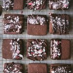 Overhead of chocolate dipped peppermint shortbread cookies on a cooling rack