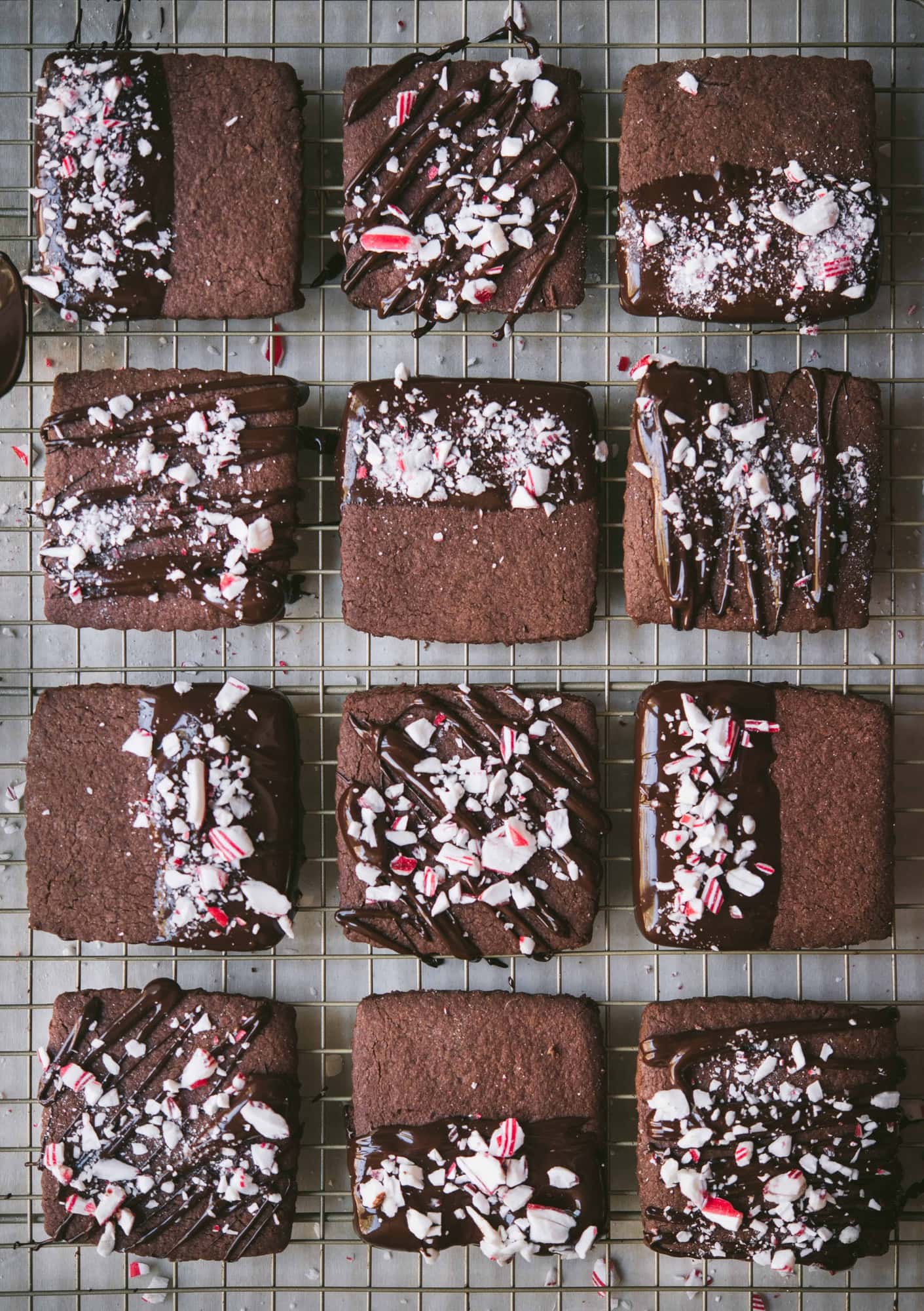 Overhead of chocolate dipped peppermint shortbread cookies on a cooling rack